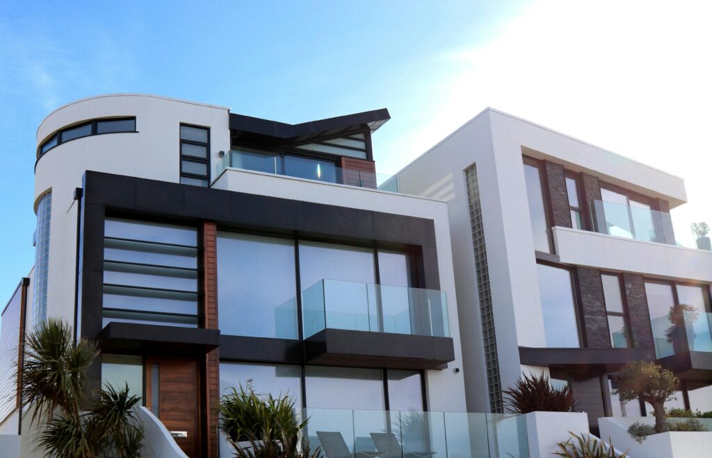 Contemporary luxury home with glass balconies in Poole, UK, showcasing modern architectural design.